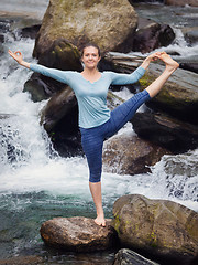 Image showing Woman doing Ashtanga Vinyasa Yoga asana outdoors at waterfall