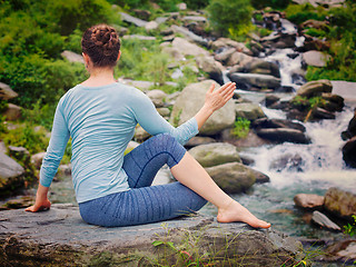 Image showing Woman doing Ardha matsyendrasana asana outdoors