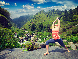 Image showing Woman doing Ashtanga Vinyasa Yoga asana Virabhadrasana 1 Warrior