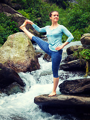 Image showing Woman doing Ashtanga Vinyasa Yoga asana outdoors at waterfall