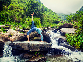 Image showing Woman doing yoga asana at waterfall