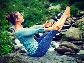 Image showing Woman doing Ashtanga Vinyasa Yoga asana Navasana - boat pose