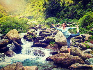 Image showing Woman doing yoga asana Natarajasana outdoors at waterfall