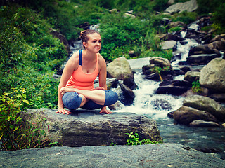 Image showing Woman doing  Ashtanga Vinyasa Yoga  arm balance asana Tolasana