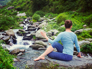 Image showing Woman doing Ardha matsyendrasana asana outdoors