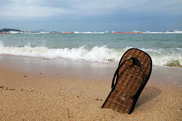 Image showing Beach slippers on a sandy beach