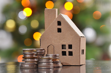 Image showing Model of house with coins on wooden table