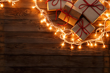 Image showing Christmas gifts on wooden background