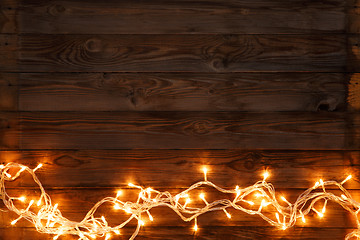 Image showing Christmas garland on brown background