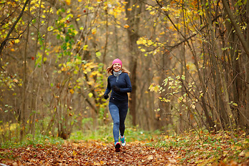 Image showing Slender girl running in park