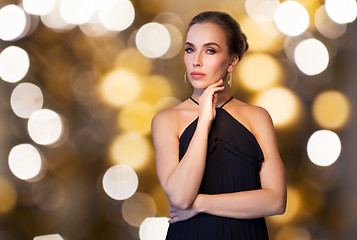 Image showing beautiful woman in black wearing diamond jewelry