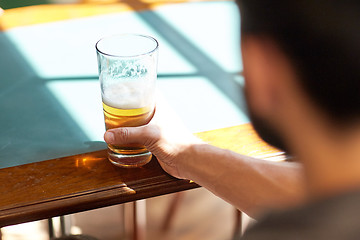 Image showing close up of man drinking beer at bar or pub