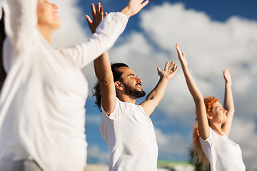 Image showing group of people making yoga exercises outdoors