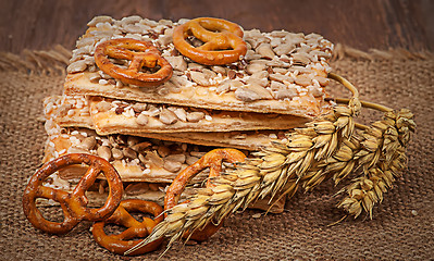 Image showing Pile cereal cookies with seeds and wheat ears on sacking