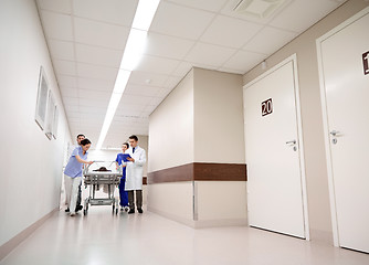 Image showing medics and patient on hospital gurney at emergency