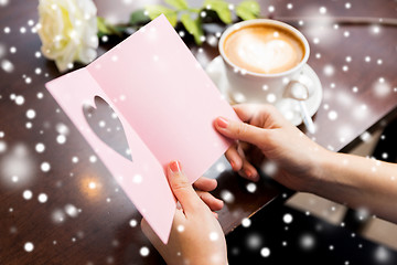 Image showing close up of woman reading greeting card and coffee