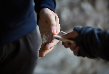 Image showing close up of addict buying dose from drug dealer