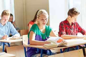 Image showing group of students with books writing school test