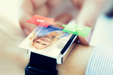 Image showing close up of hand with incoming call on smart watch