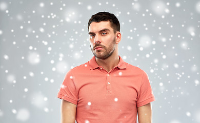 Image showing suspicious man thinking over snow background