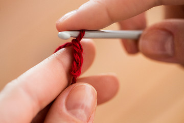 Image showing close up of hands knitting with crochet hook