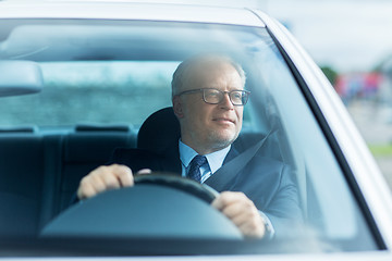 Image showing happy senior businessman driving car