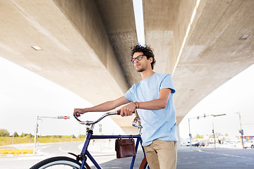 Image showing hipster man with fixed gear bike under bridge