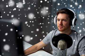 Image showing man in headset playing computer video game at home