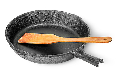 Image showing Old cast iron pan with wooden spatula
