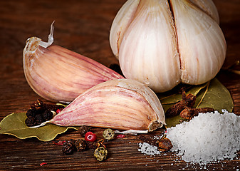 Image showing Clove of garlic and spices pile of salt