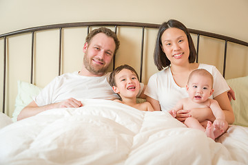 Image showing Mixed Race Chinese and Caucasian Baby Boys Laying In Bed with Th