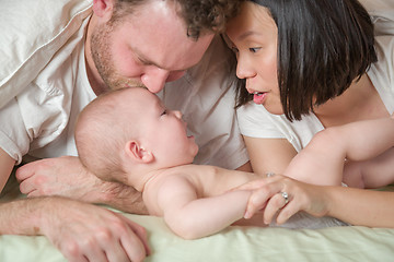 Image showing Mixed Race Chinese and Caucasian Baby Boy Laying In Bed with His