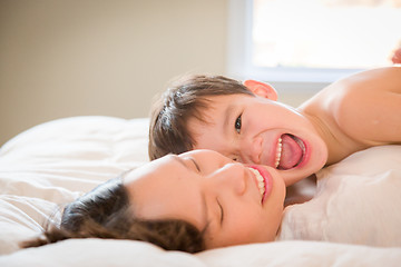 Image showing Mixed Race Chinese and Caucasian Boy Laying In His Bed with His 