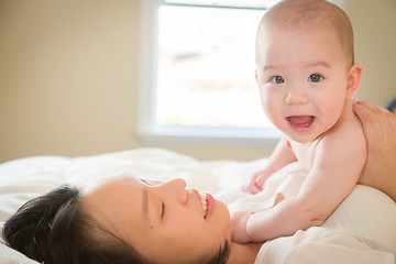 Image showing Mixed Race Chinese and Caucasian Baby Boy Laying In Bed with His