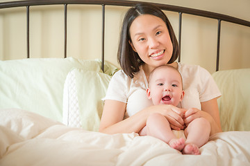 Image showing Mixed Race Chinese and Caucasian Baby Boy Laying In Bed with His