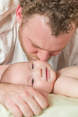 Image showing Mixed Race Chinese and Caucasian Baby Boy In Bed with His Father