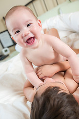 Image showing Mixed Race Chinese and Caucasian Baby Brothers Having Fun Laying