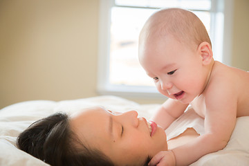 Image showing Mixed Race Chinese and Caucasian Baby Boy Laying In Bed with His