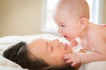 Image showing Mixed Race Chinese and Caucasian Baby Boy Laying In Bed with His