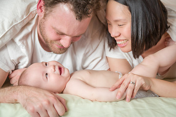 Image showing Mixed Race Chinese and Caucasian Baby Boy Laying In Bed with His