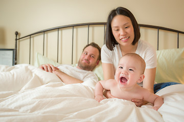 Image showing Chinese and Caucasian Baby Boy Laying In Bed with His Parents