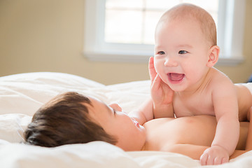 Image showing Mixed Race Chinese and Caucasian Baby Brothers Having Fun Laying