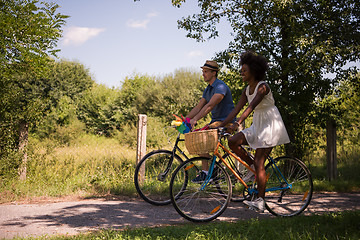 Image showing Young multiethnic couple having a bike ride in nature