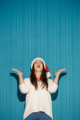 Image showing Surprised christmas girl wearing a santa hat