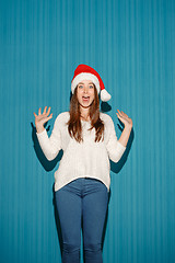 Image showing Surprised christmas girl wearing a santa hat