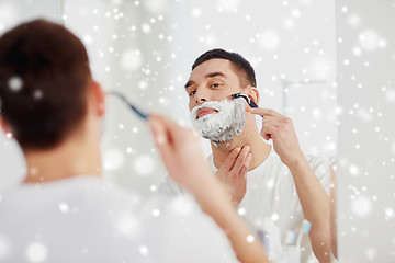 Image showing man shaving beard with razor blade at bathroom