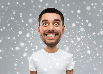 Image showing man with funny face over snow background