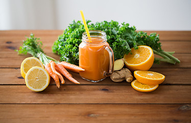 Image showing glass jug of carrot juice, fruits and vegetables