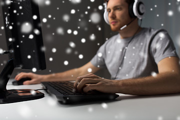 Image showing man with headset playing computer video game