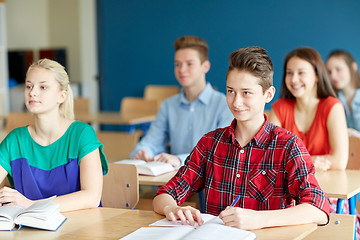 Image showing group of students with notebooks at school lesson